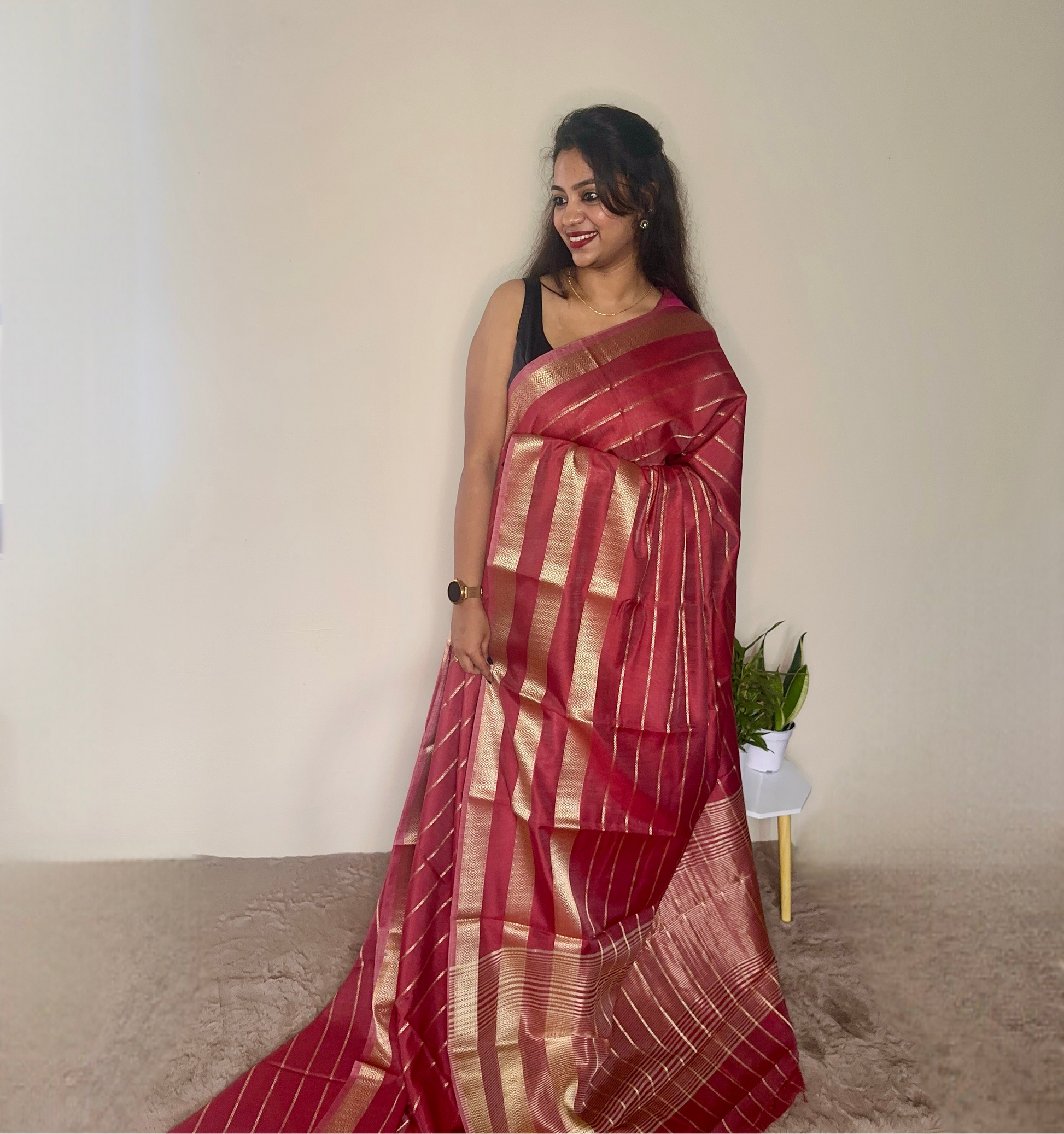 Model wearing a Maroon soft cotton saree with gold zari detailing, styled for festive wear – Jayithva