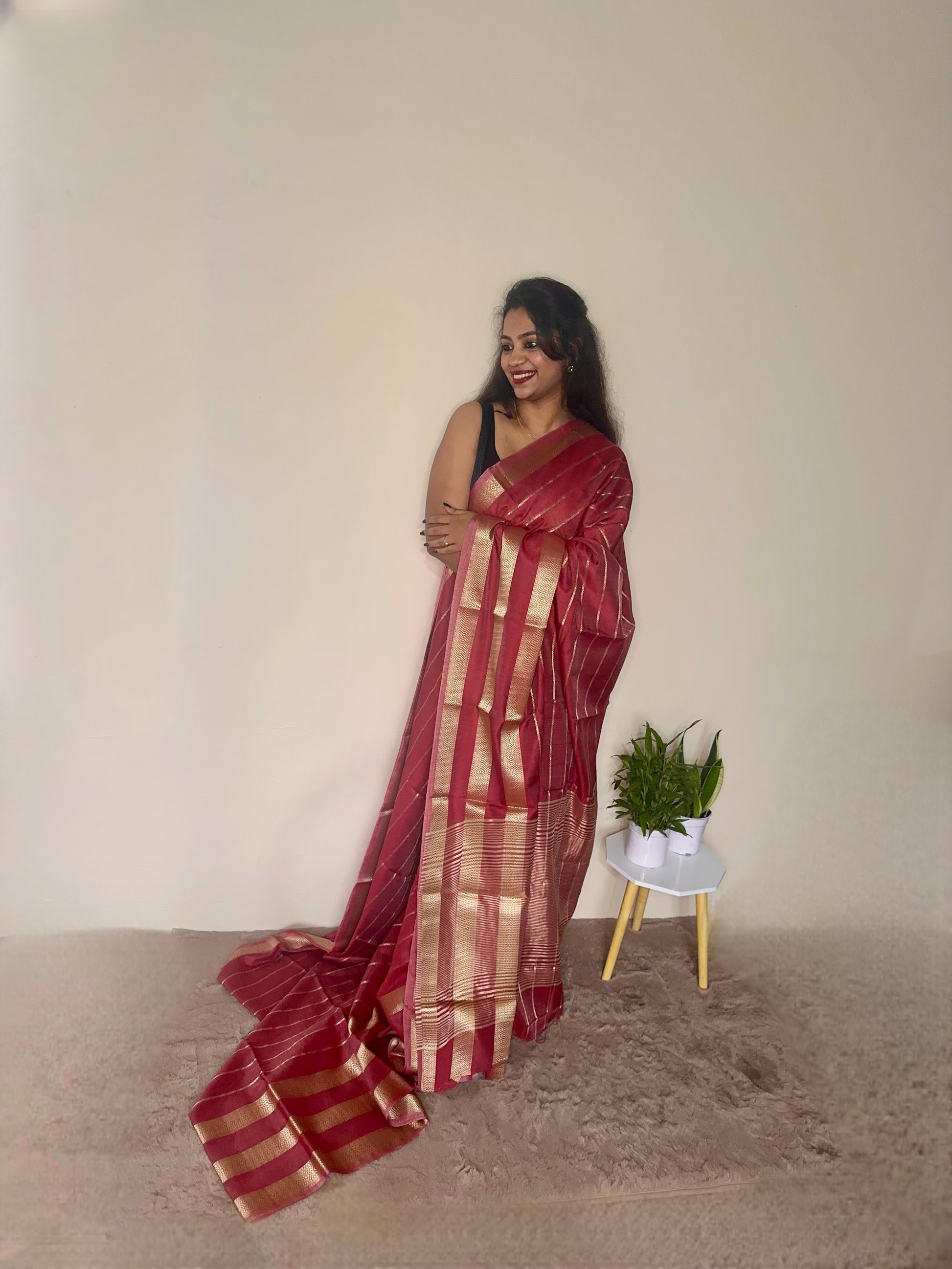 Model wearing a Maroon soft cotton saree with gold zari detailing, styled for festive wear – Jayithva