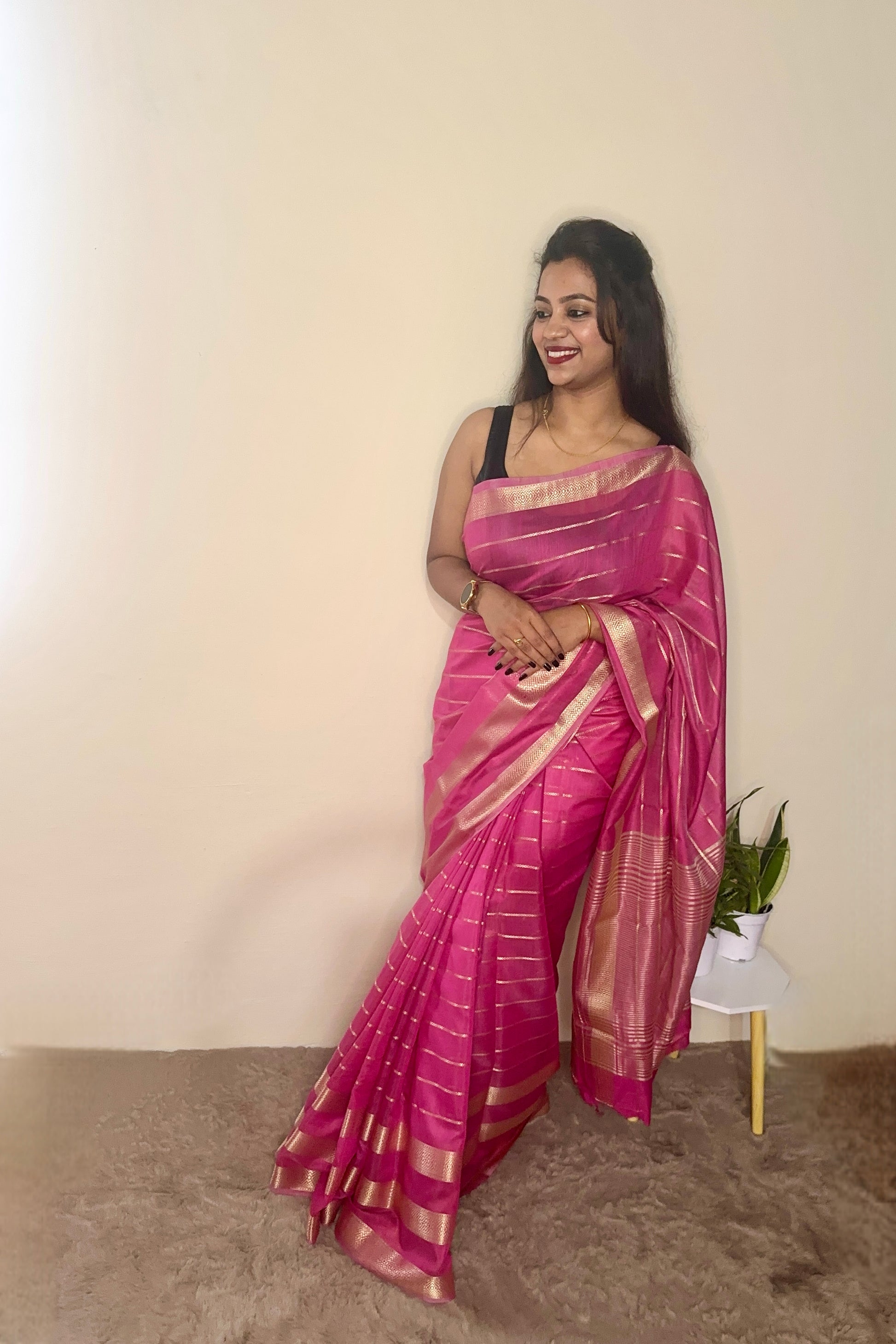 Model wearing a Pink soft cotton saree with gold zari detailing, styled for festive wear – Jayithva