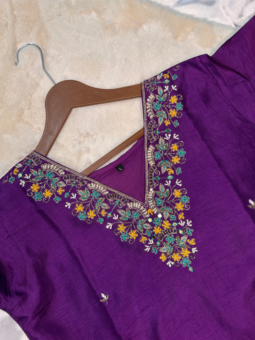 Close-up of hand embroidered neckline on purple dola silk kurta set