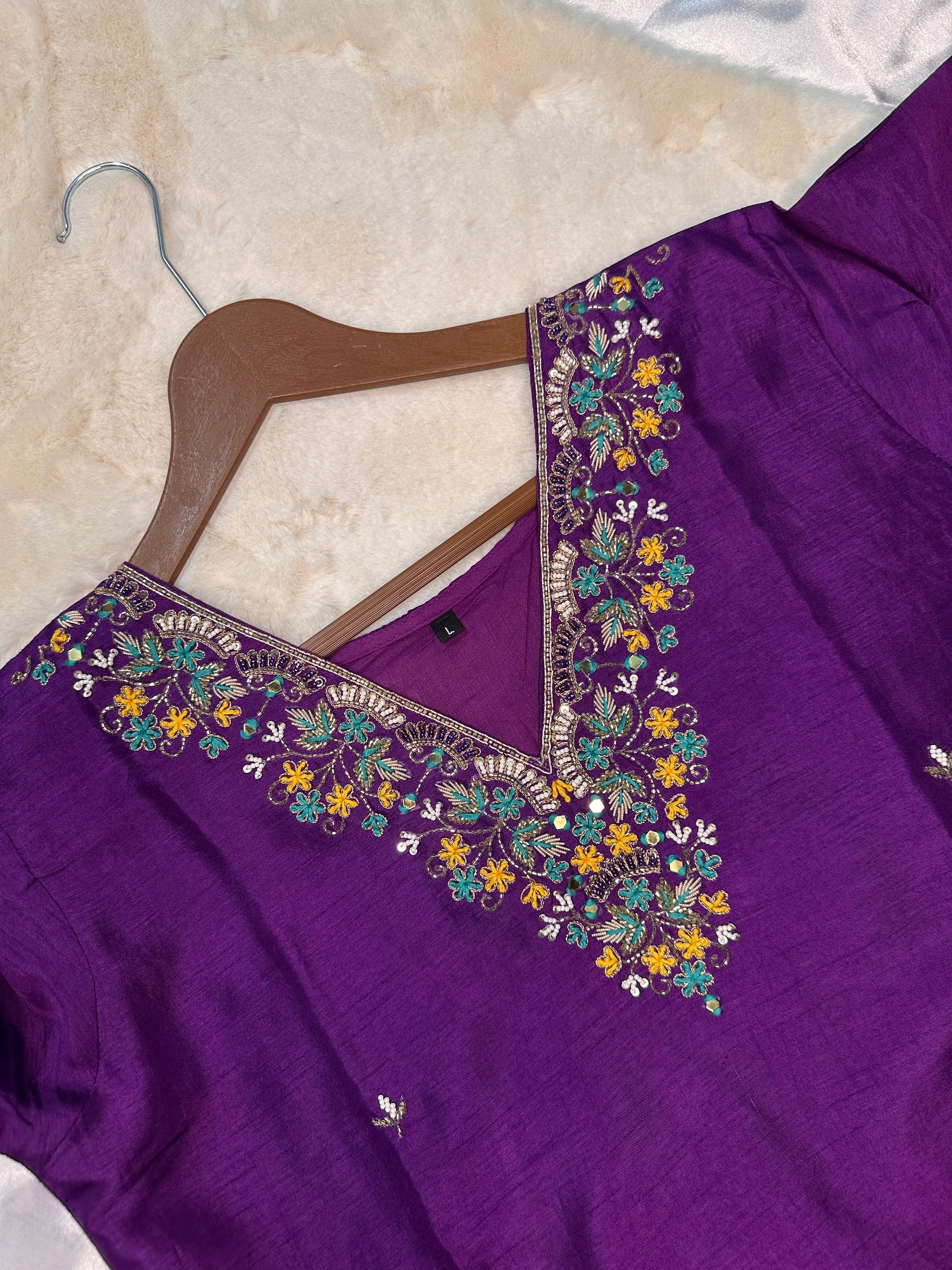 Close-up of hand embroidered neckline on purple dola silk kurta set
