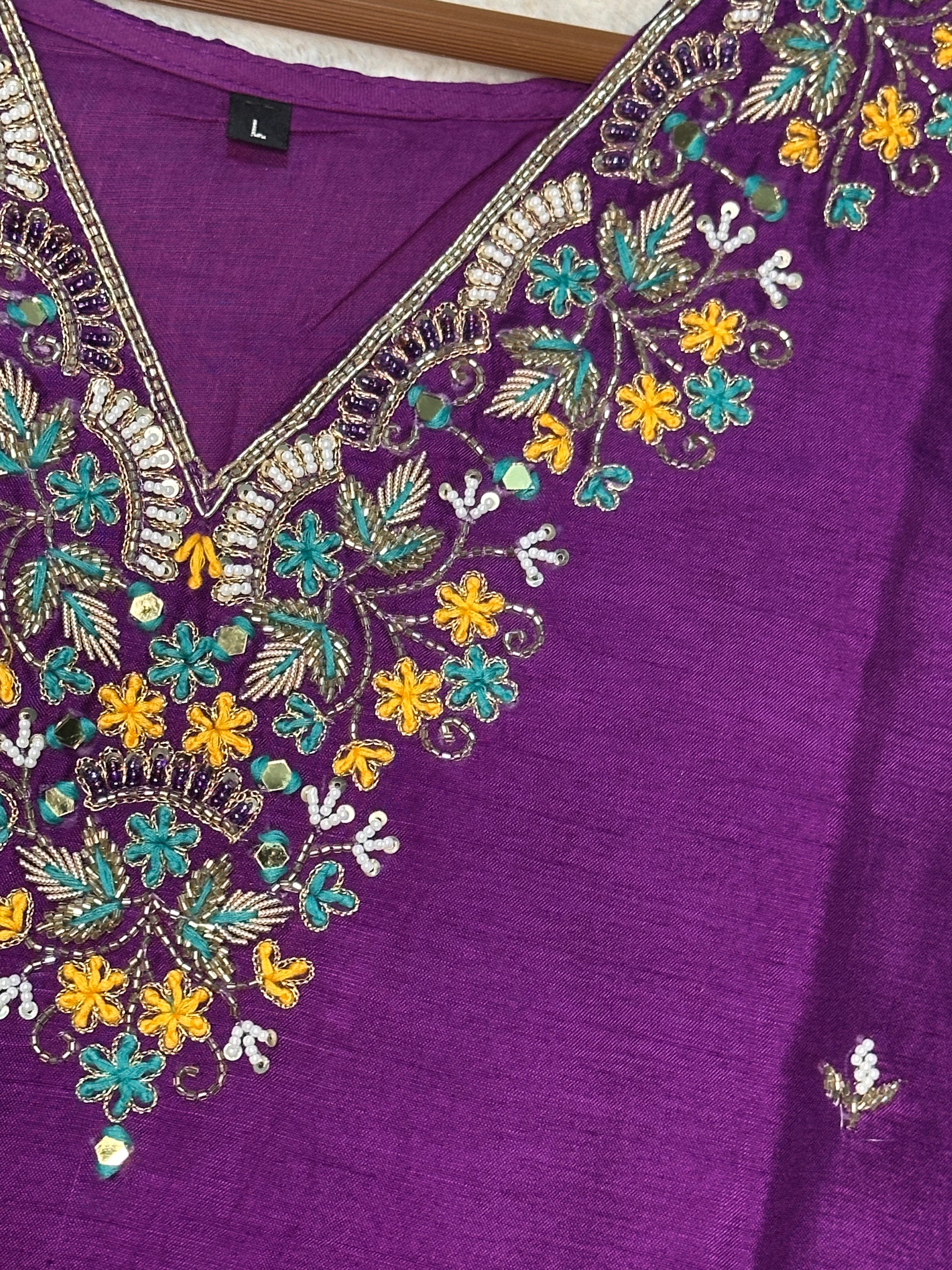 Close-up of hand embroidered neckline on purple dola silk kurta set