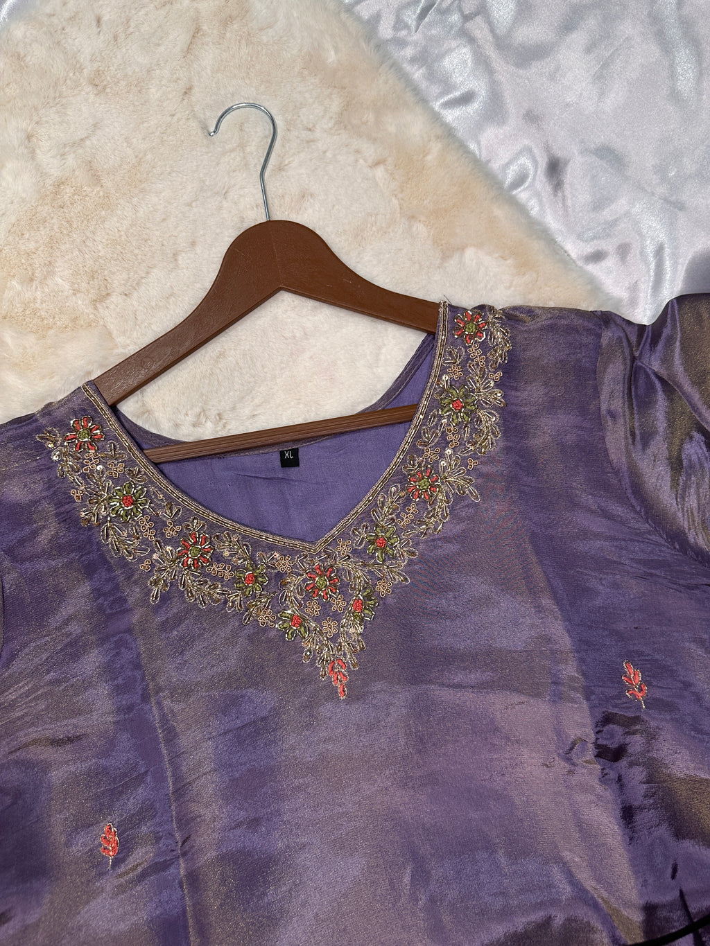 Close-up of embroidered neckline on purple tissue silk kurta