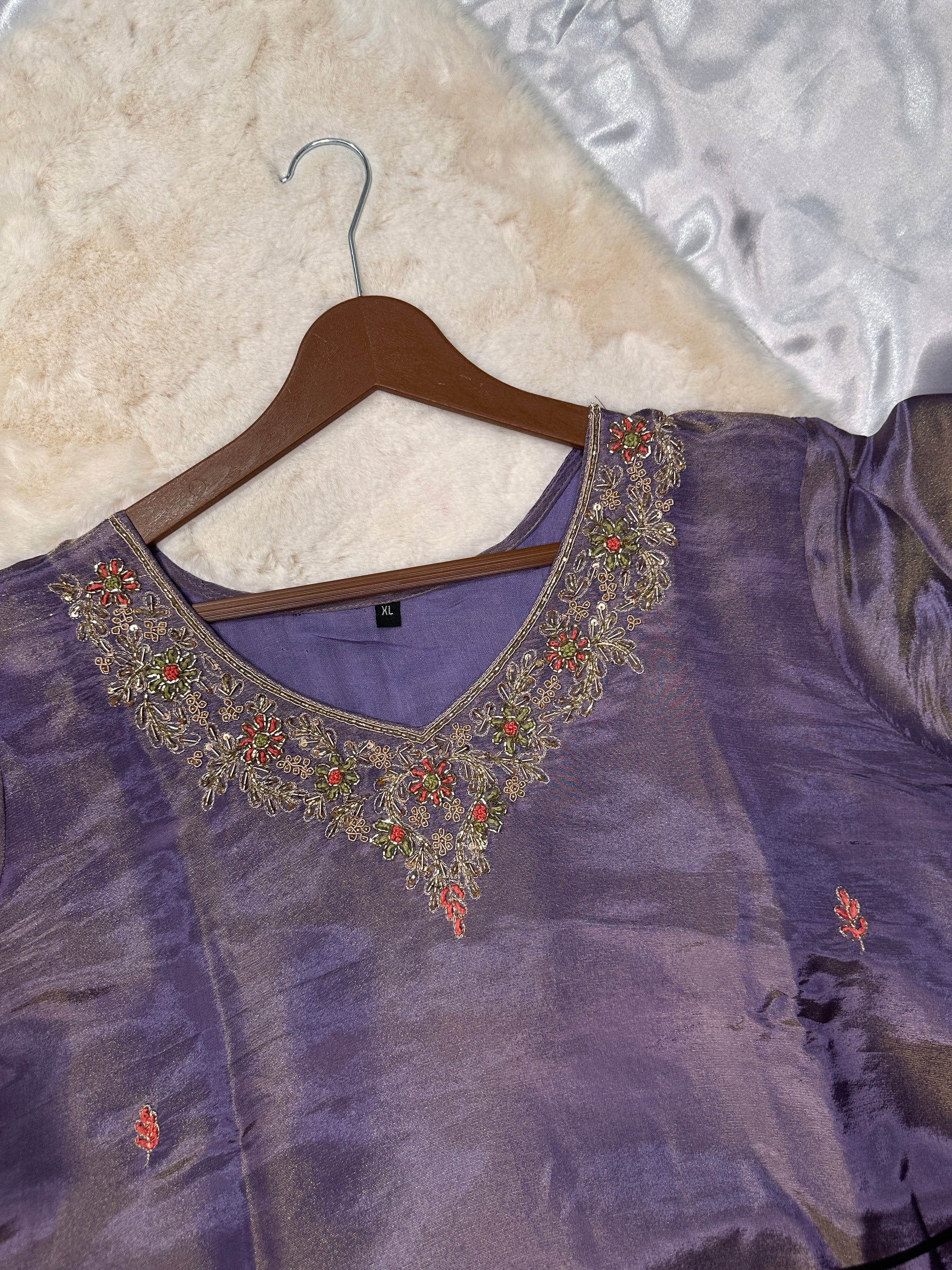 Close-up of embroidered neckline on purple tissue silk kurta
