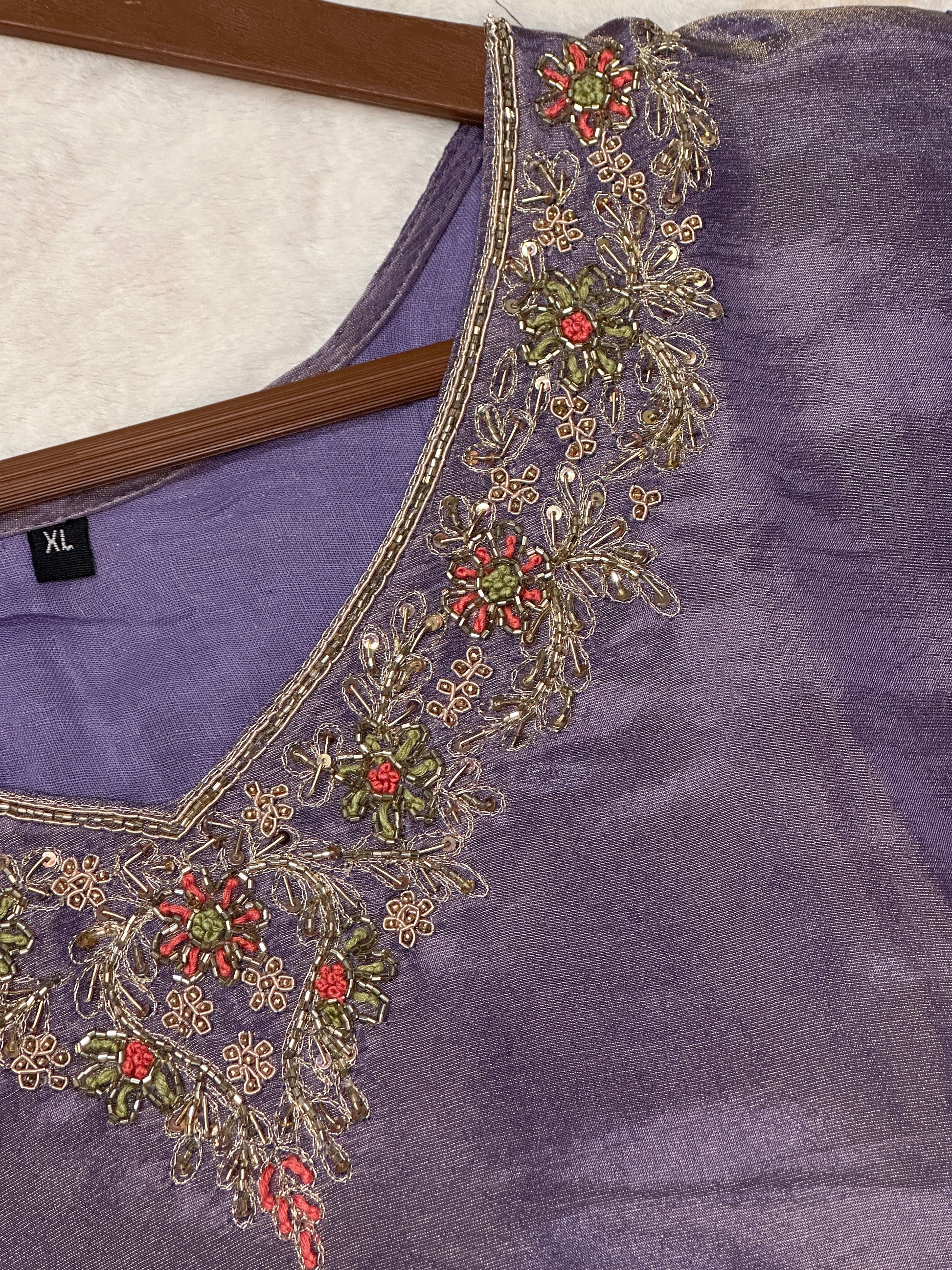 Close-up of embroidered neckline on purple tisdue silk kurta